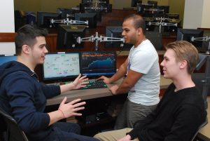 Arman Hodzic (BUS ’15) (far left) says the three classes he took in the Finance Lab gave him a jump-start on his career. 