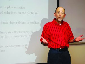 Instructor Philip Gisi teaches a course on Six Sigma.
