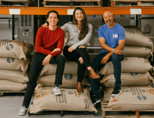 Alumna Leticia Hutchins (center) co-founded Alma Coffee with her husband, Harry (left), and father, Al Lopez (right). The business roasts and sells coffee from Honduras, where her family has been farming for five generations.