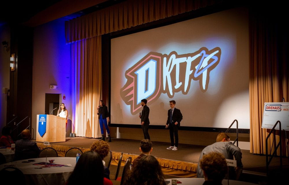Pictured from the Drift Team (L to R): Shivani Patel (at podium), Suzanna Linek, Omar Hatamleh, Ethan Brock. [The fifth member, Arshdeep Singh, is not pictured.]