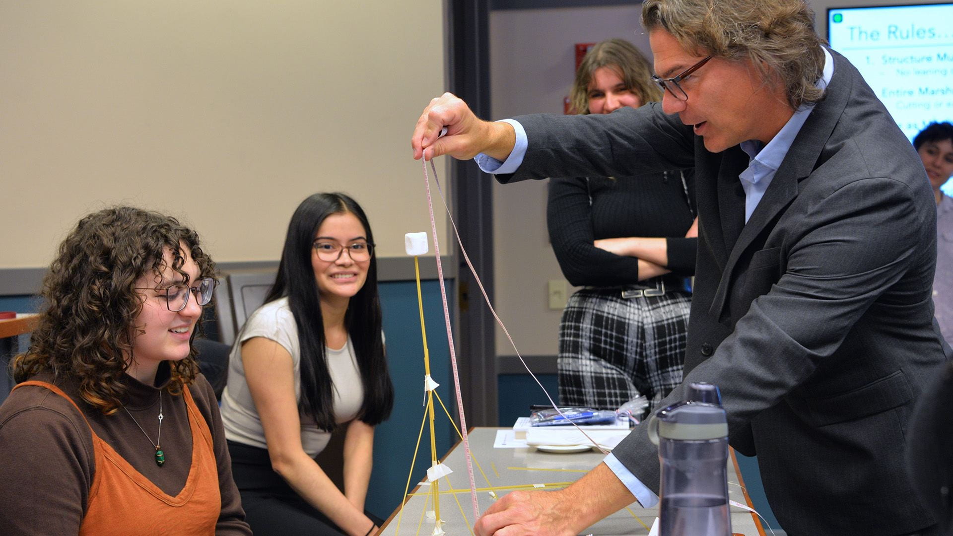 Students building marshmallow structure: Student teams competed to build the tallest spaghetti-and-marshmallow structure -- and learn how different kinds of leaders emerge from within teams in the process. 