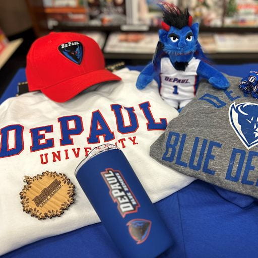 A collection of DePaul gear, including a thermos, a grey and a white sweatshirt that say DePaul, a red DePaul Blue Demons hat, and a miniature DIBS (DePaul's mascot) plushie. 