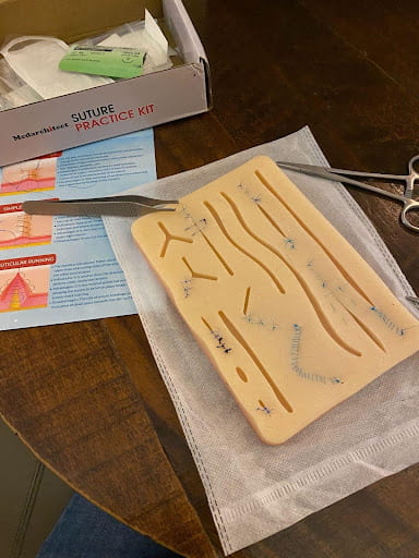 An image of a suture practice kit, the kind that might be used in a medical sciences class.