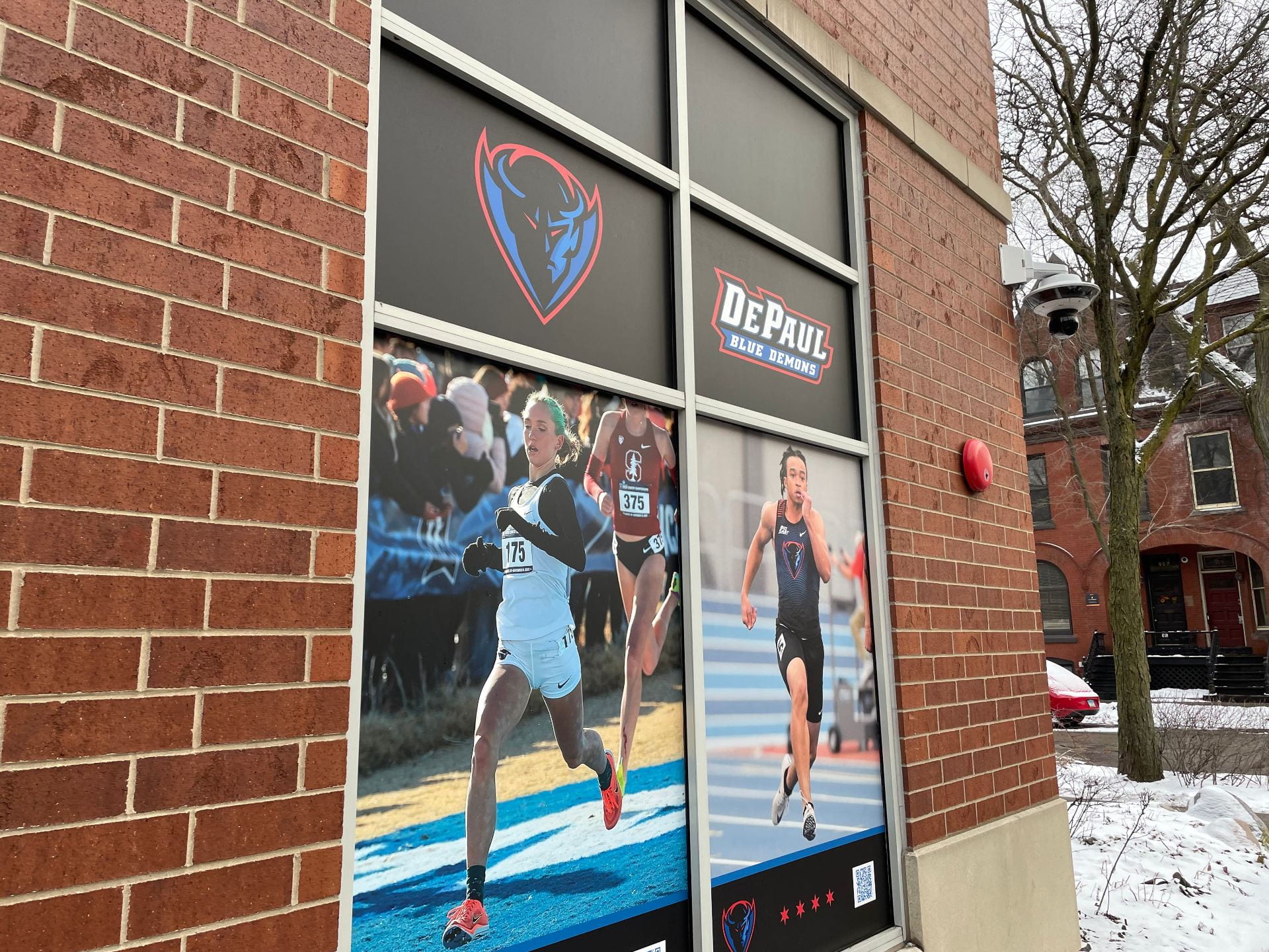 A photo of a window display of DePaul University athletes at McGrath Phillips Arena on DePaul University’s Lincoln Park Campus.