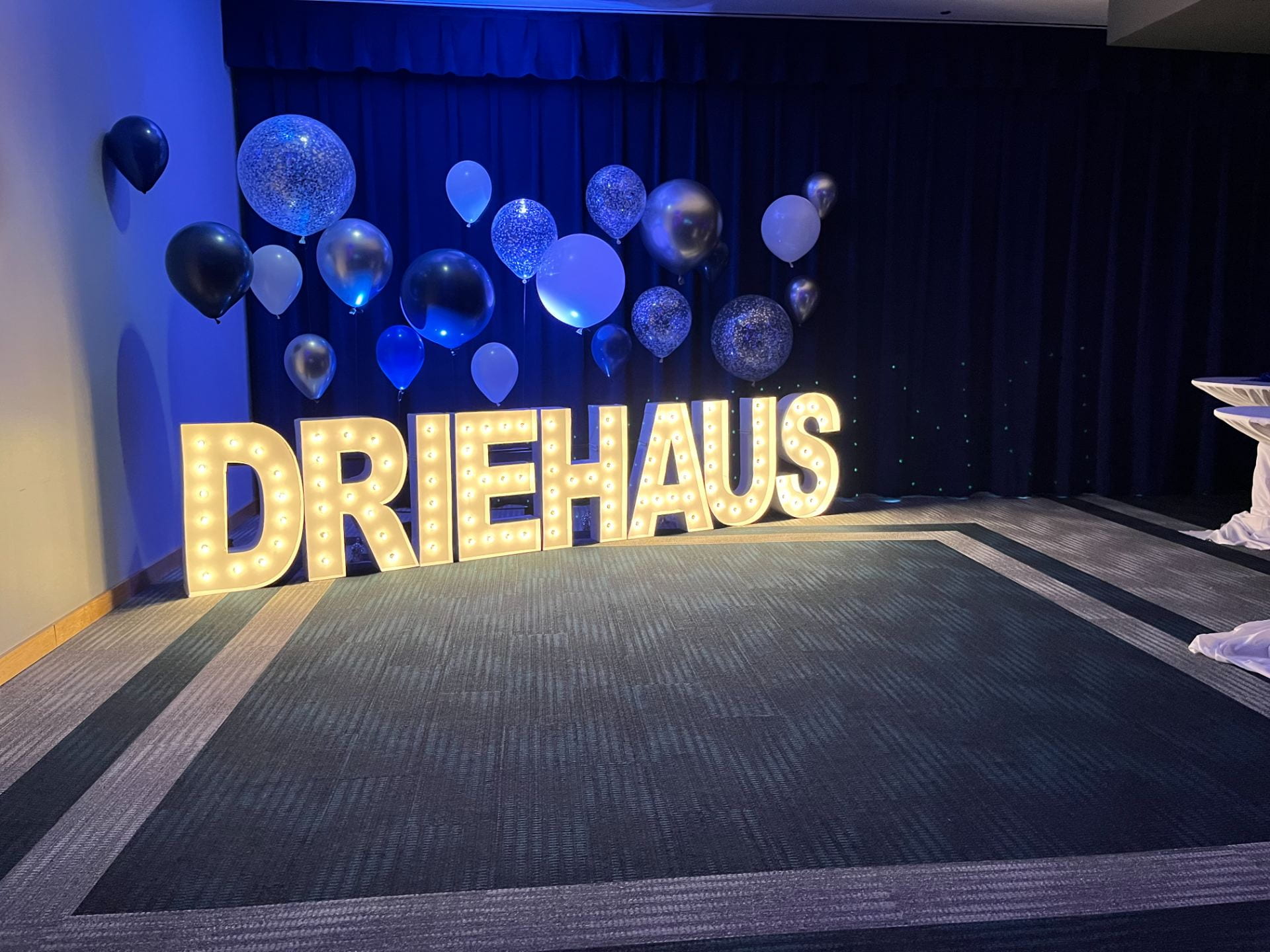 The Driehaus sign lights up with a balloon backdrop.