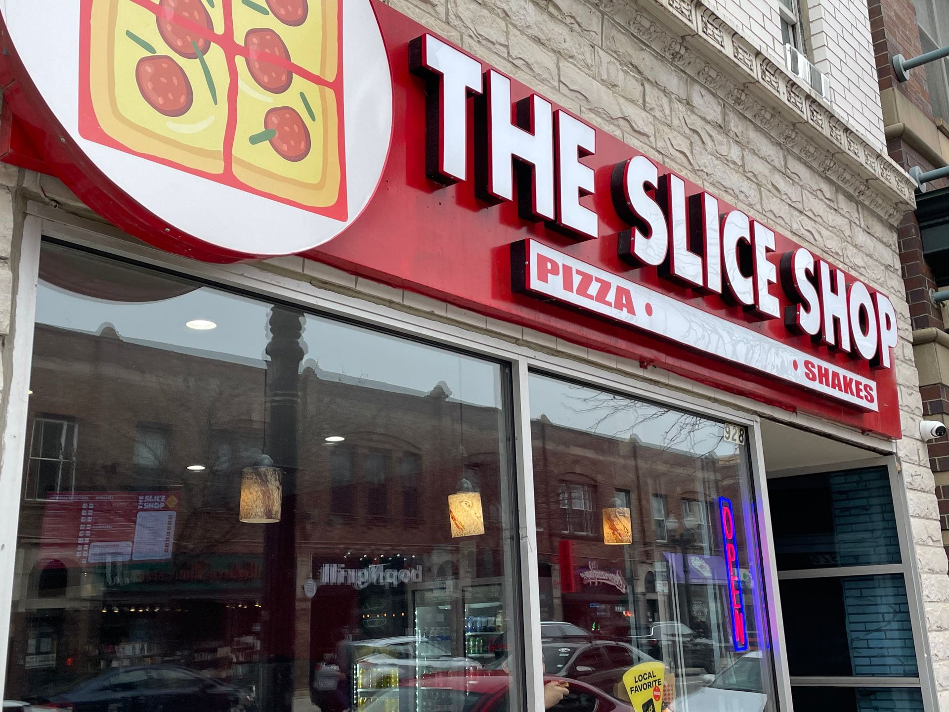 A photo showing the front of Slice Shop, a pizza restaurant on Belmont Ave. in Chicago.
