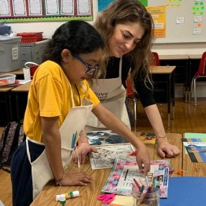 Kara Anton, founder and president of Give Kids Art, a 501(c)(3) nonprofit that provides art programming and art kits to underserved children, helps a child create art.