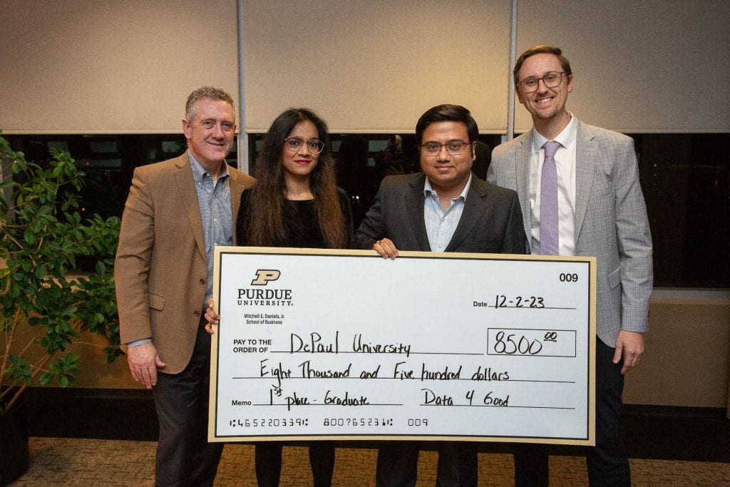 Syeda and Biswas hold up a check celebrating their win